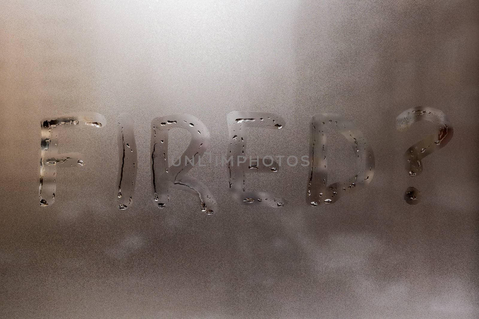 the question fired handritten on wet window glass at cloudy weather - close-up with selective focus and background blur