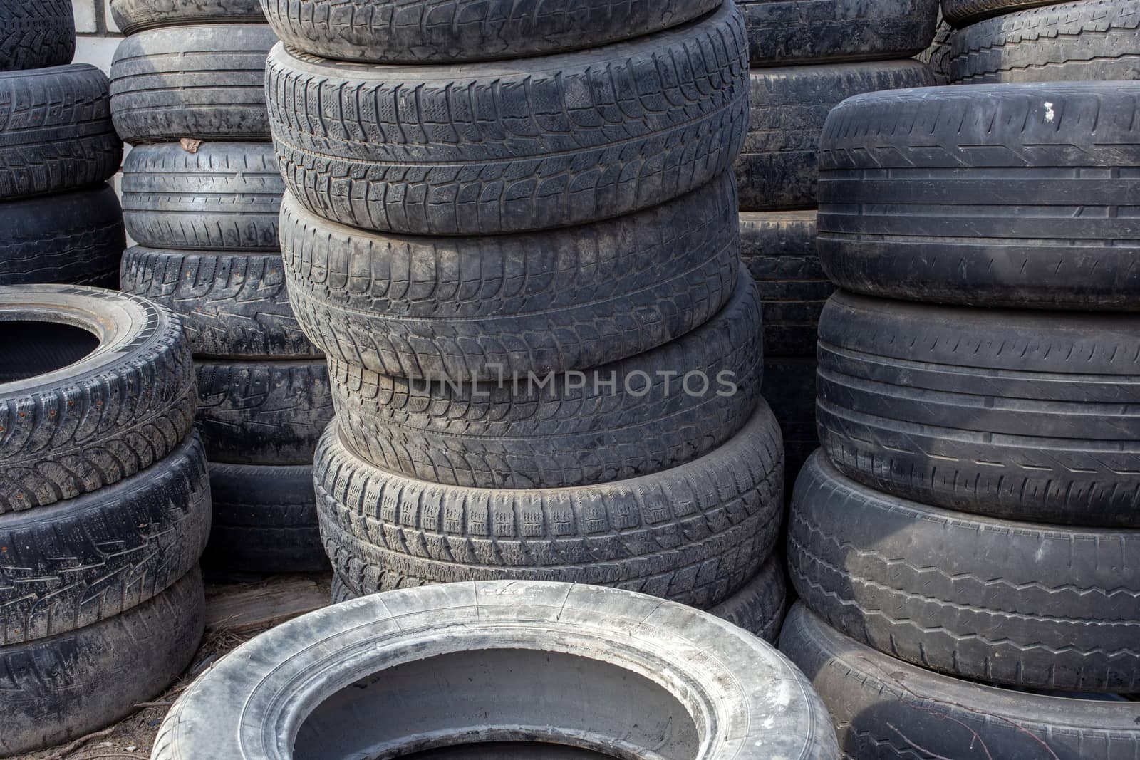 old used small car tires stacks full frame background.