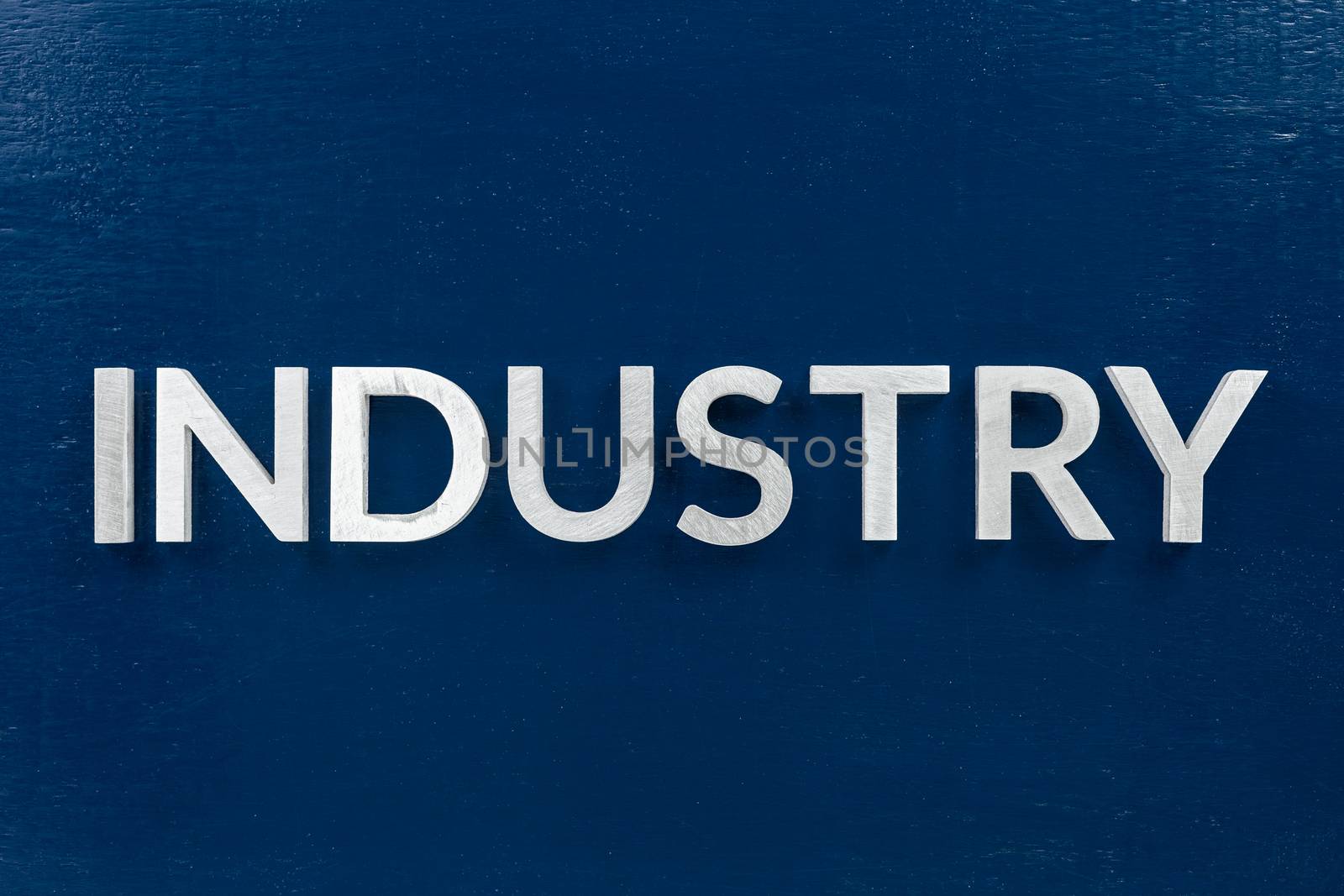 the word industry laid weith white letters over blue flat background in center of picture with directly above perspective