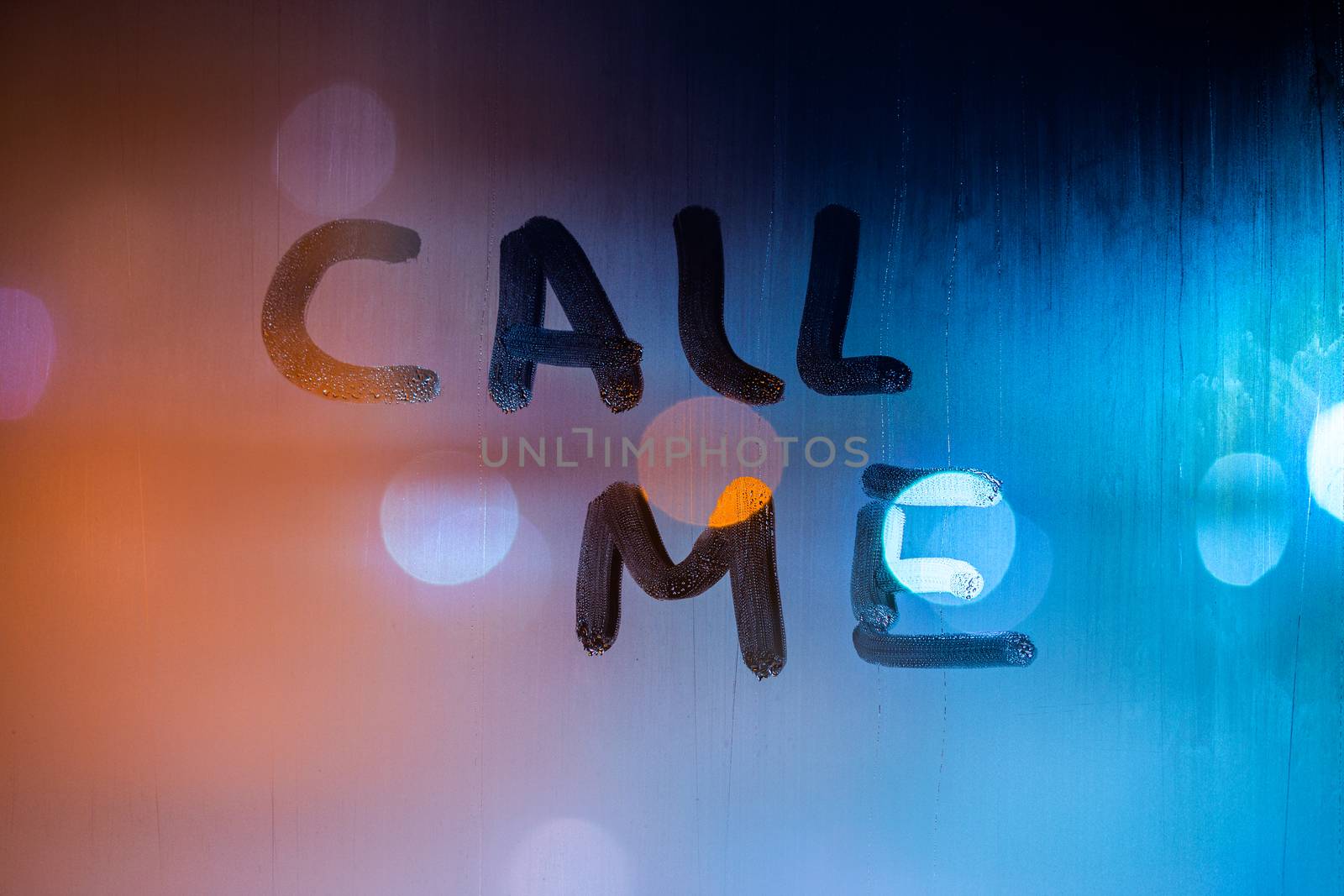 the words call me handwritten by finger on night foggy wet window glass by z1b