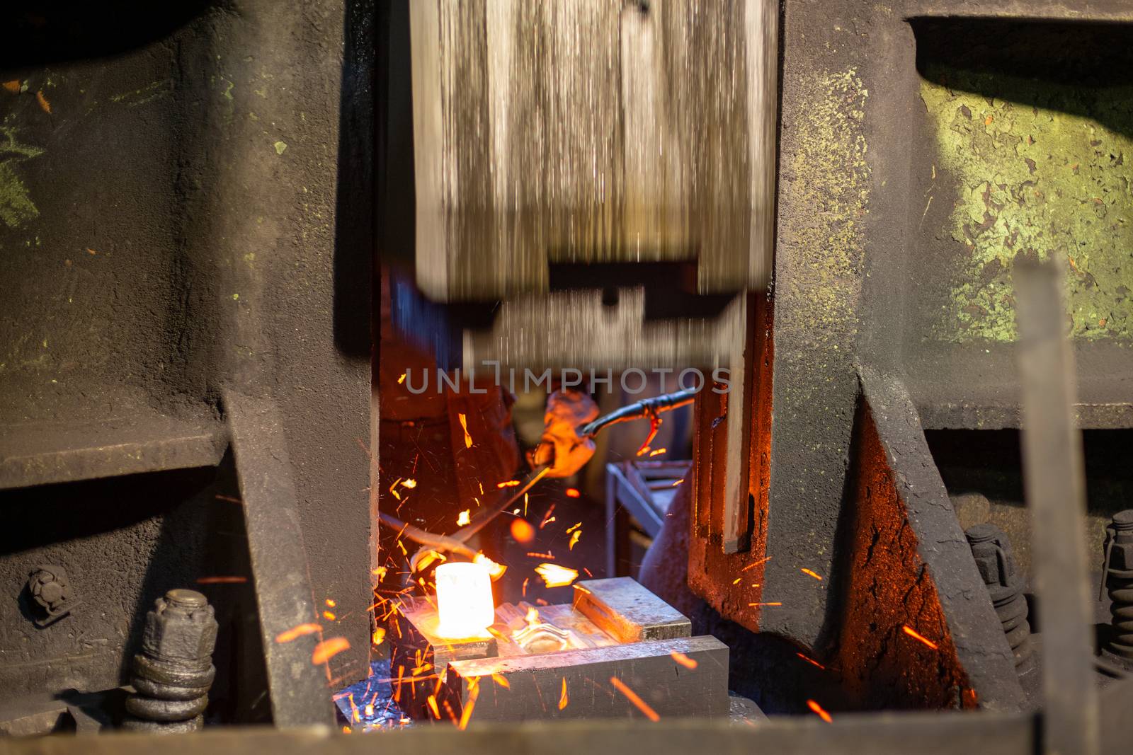 close-up picture of hot steel forging process with big mechanical hammer machine by z1b