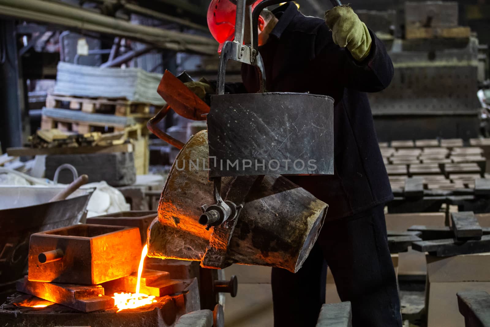 Industrial chill casting. The process of for filling out mold with molten metal from ladle.