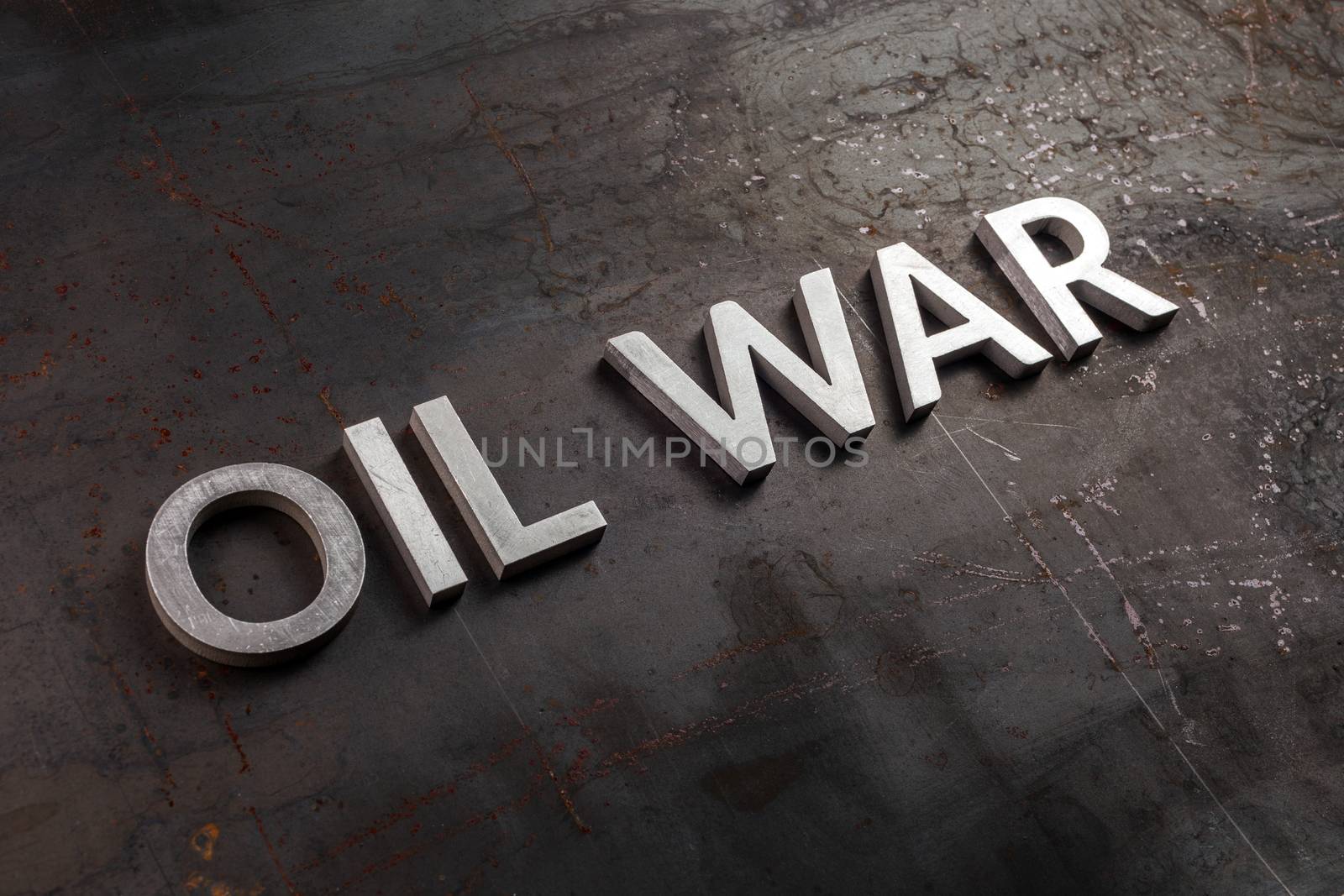 words oil war laid in line with silver metal letters on rusted heavy hot rolled uncoated steel sheet surface in diagonal perspective by z1b