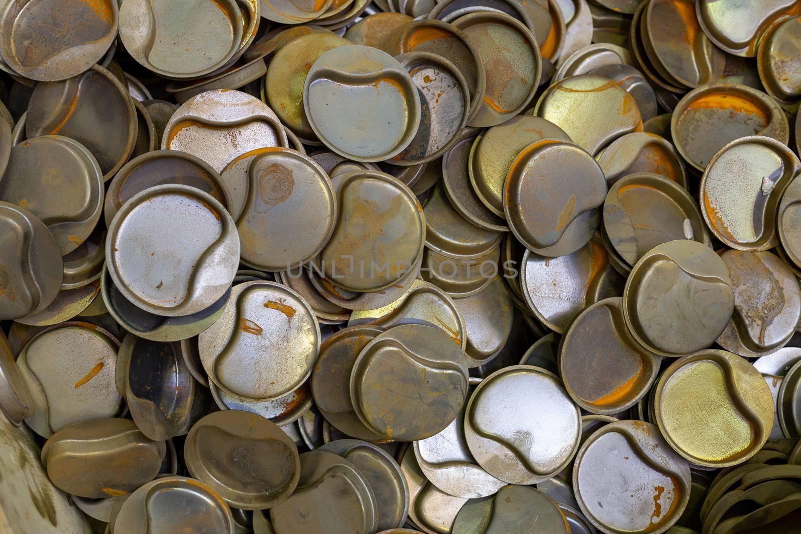 a pile of many rusted sheet steel stamped parts - close-up with selective focus and blur