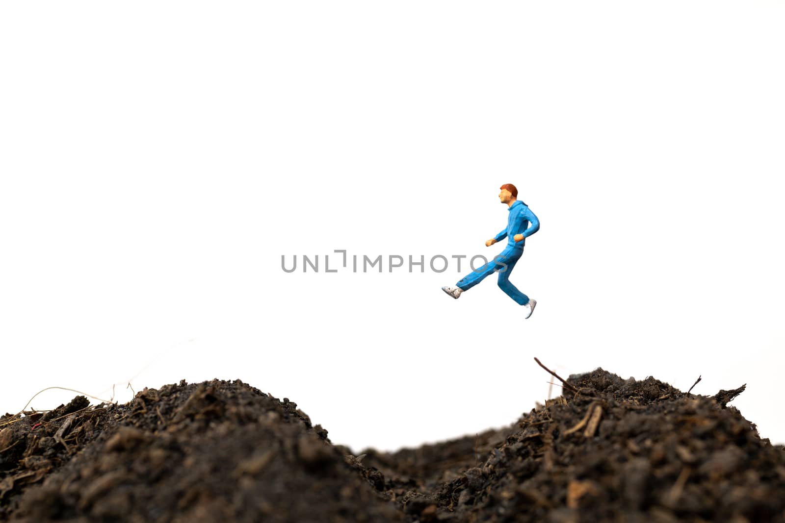 Miniature people : Man Running on The ground  isolated on white background , Run for health concept.
