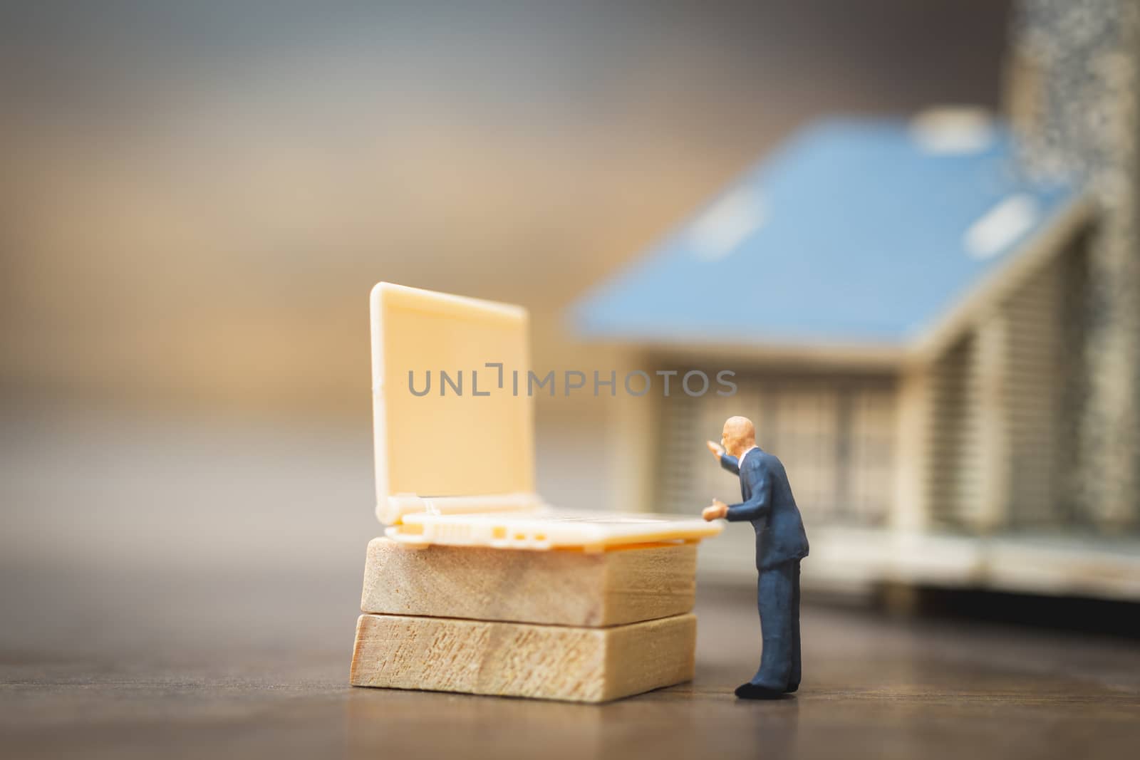Miniature people business man working with computer labtop , Work at home concept