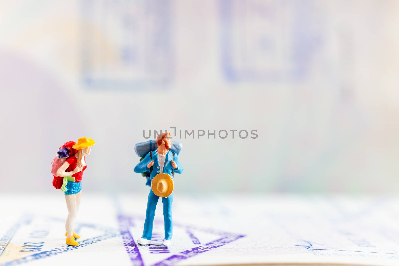 Miniature people : Traveler with backpack walking on Passport , Travel and Adventure concepts.