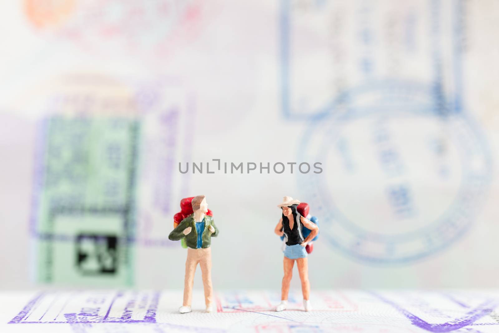 Miniature people : Traveler with backpack walking on Passport , Travel and Adventure concepts.