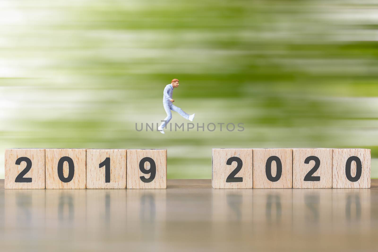 Miniature people Jump from number 2019 to number 2020 , Happy new year concepts.