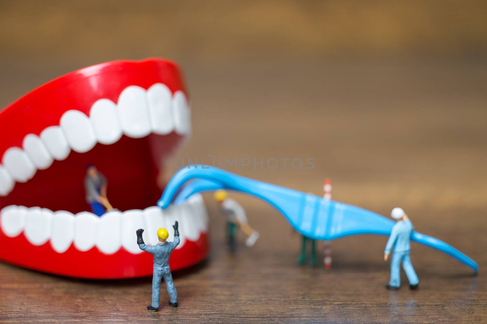 Miniature people : Worker team repairing a tooth by sirichaiyaymicro