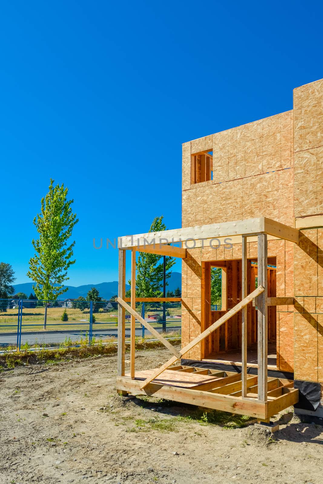 New family townhouse under construction on blue sky background