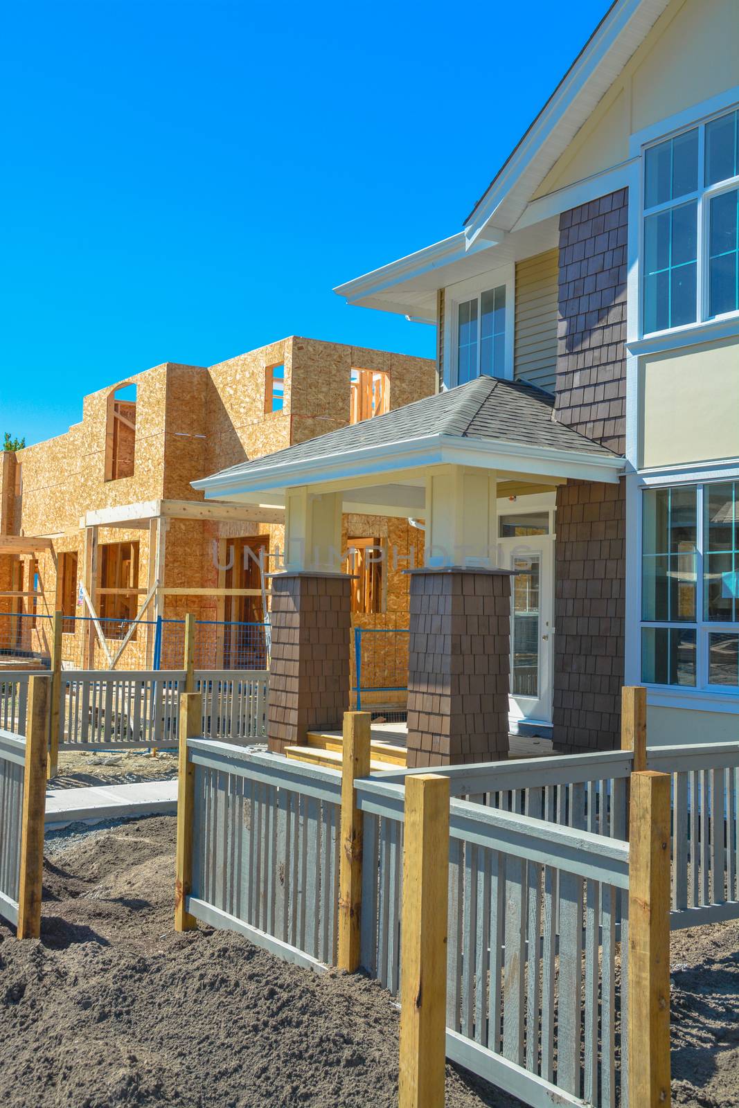 Front yard and entrance of brand new family townhouses on construction completion stage.