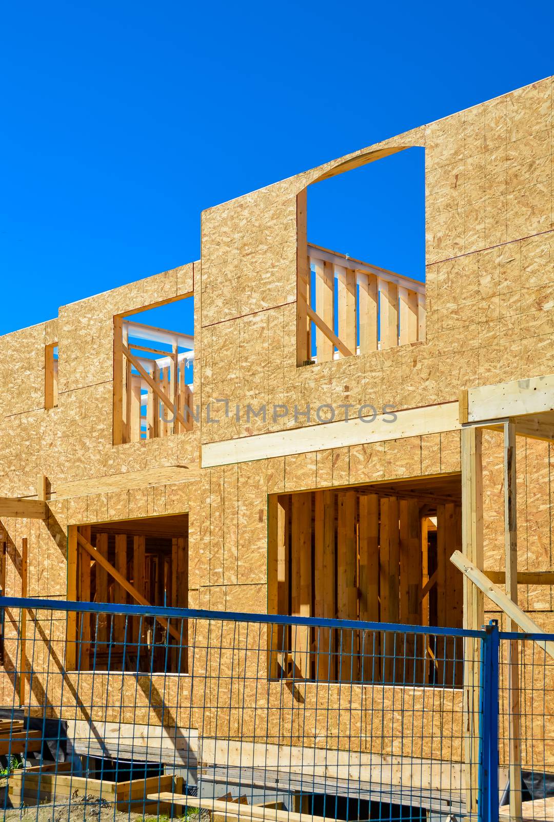 New family townhouse under construction on blue sky background