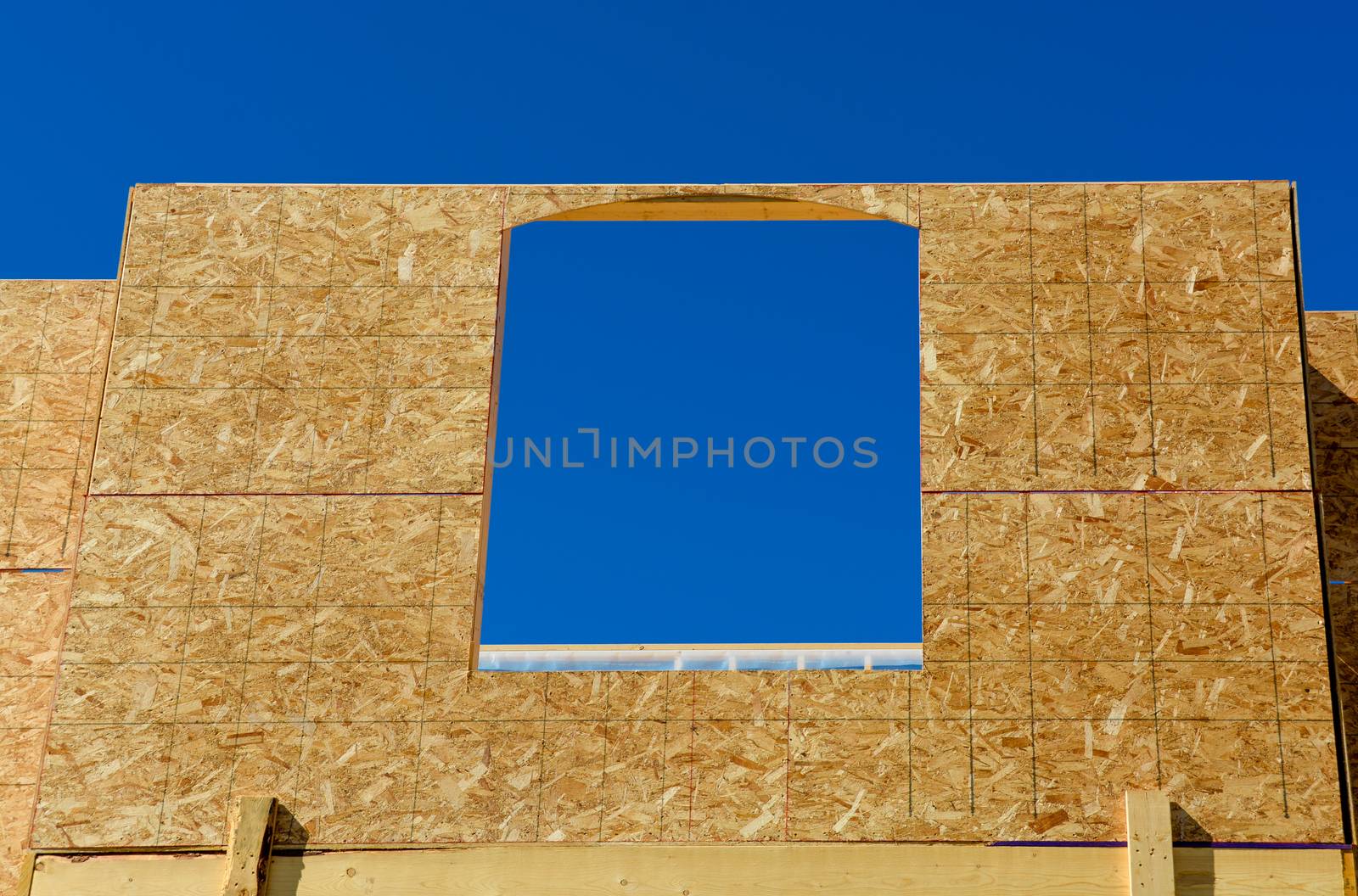 Window frame of new low rise building on blue sky background