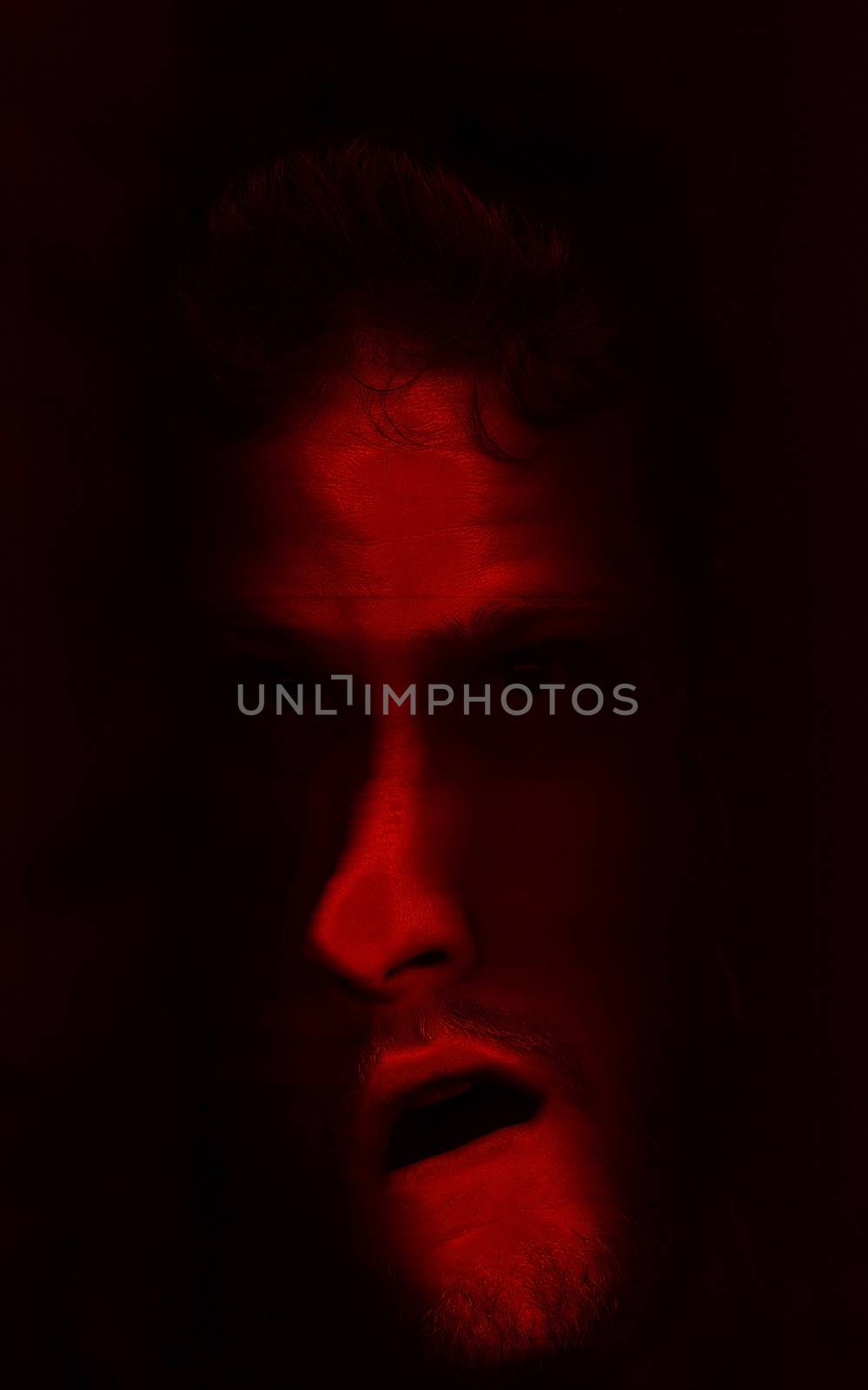 Distorted man's face in red color