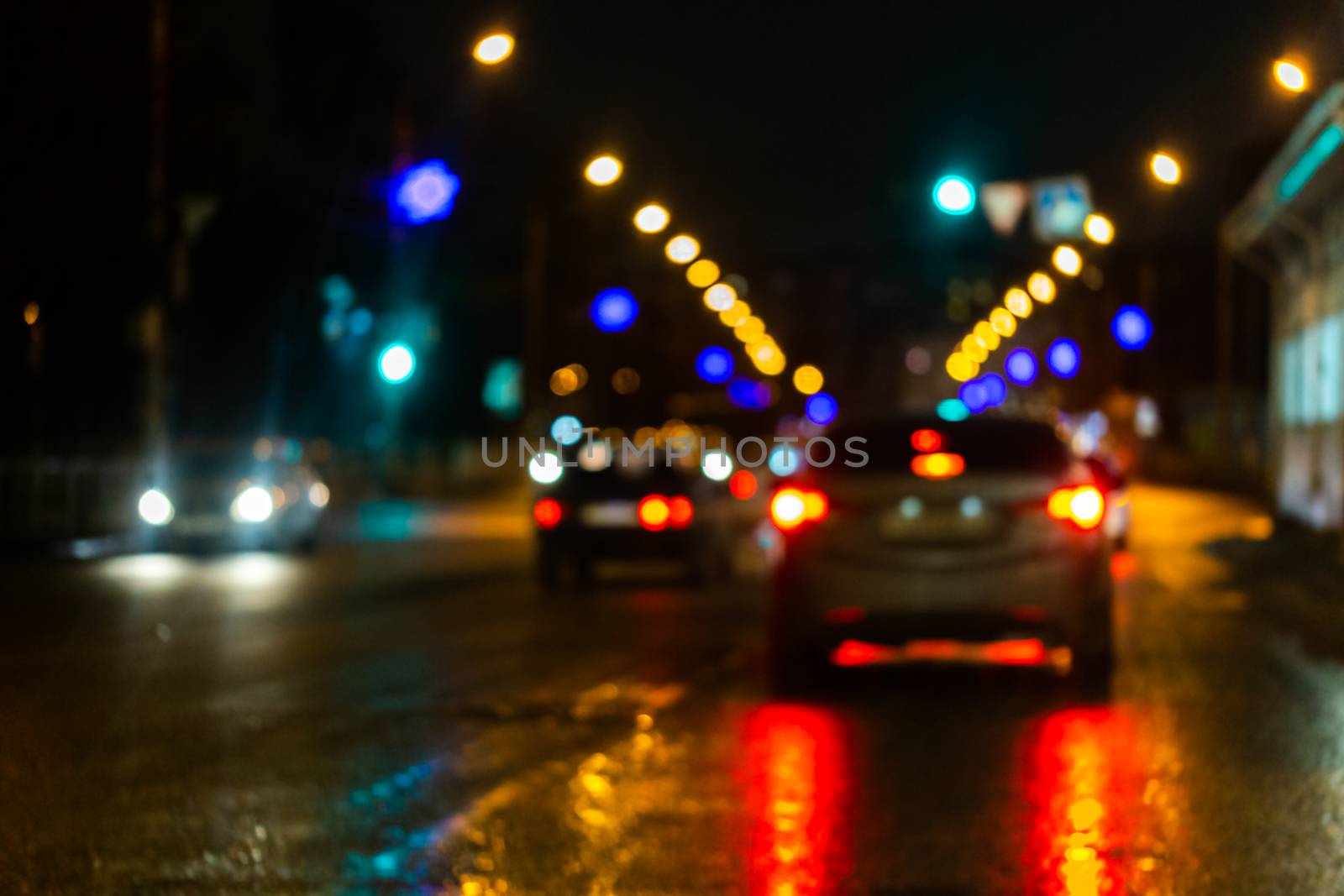 Defocused picture of night street car traffic - view from road. Colorful night life background. by z1b