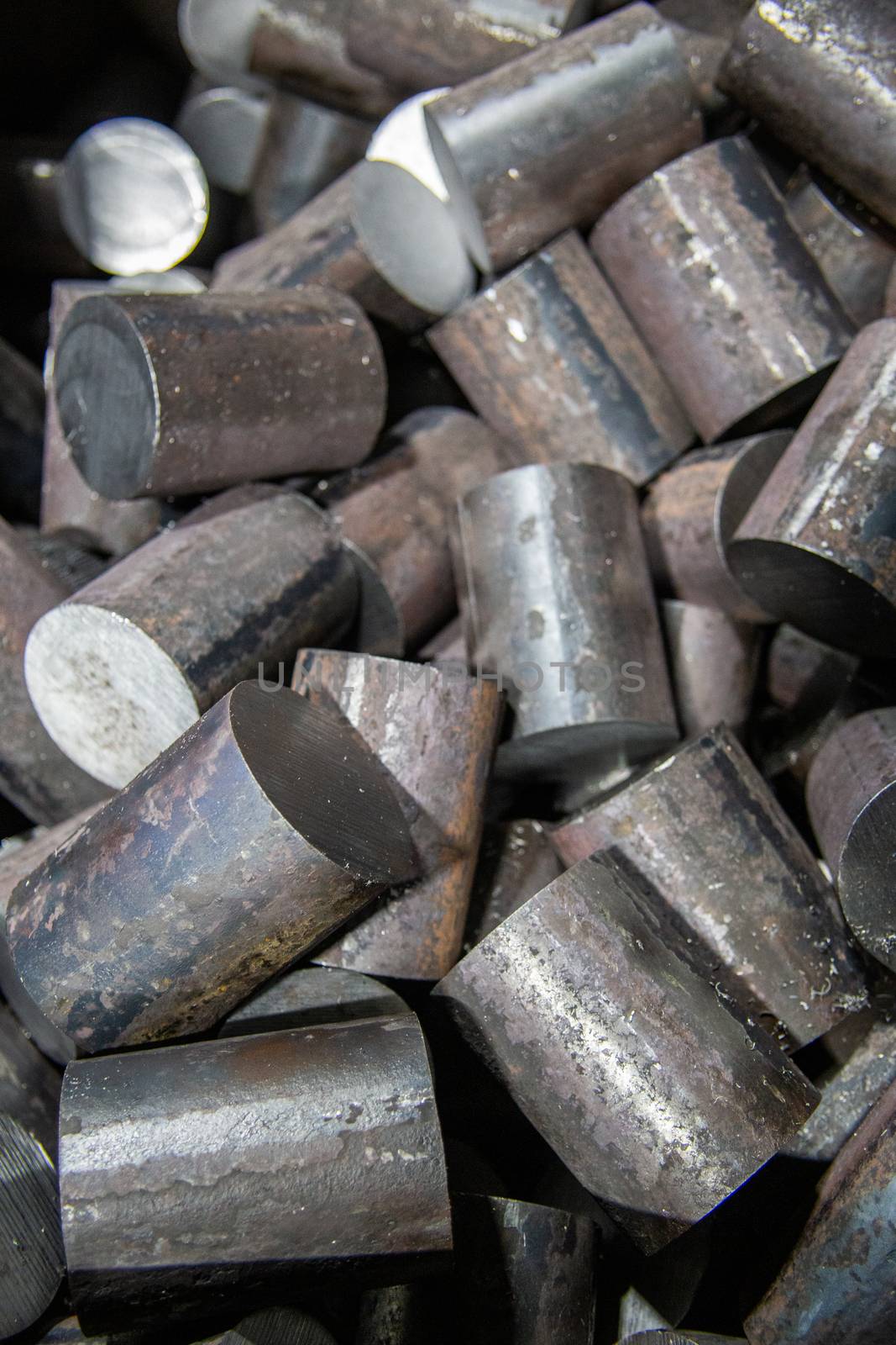 a pile of raw steel short rods cutted by saw - workpieces prepaired for forging, close-up with selective focus by z1b