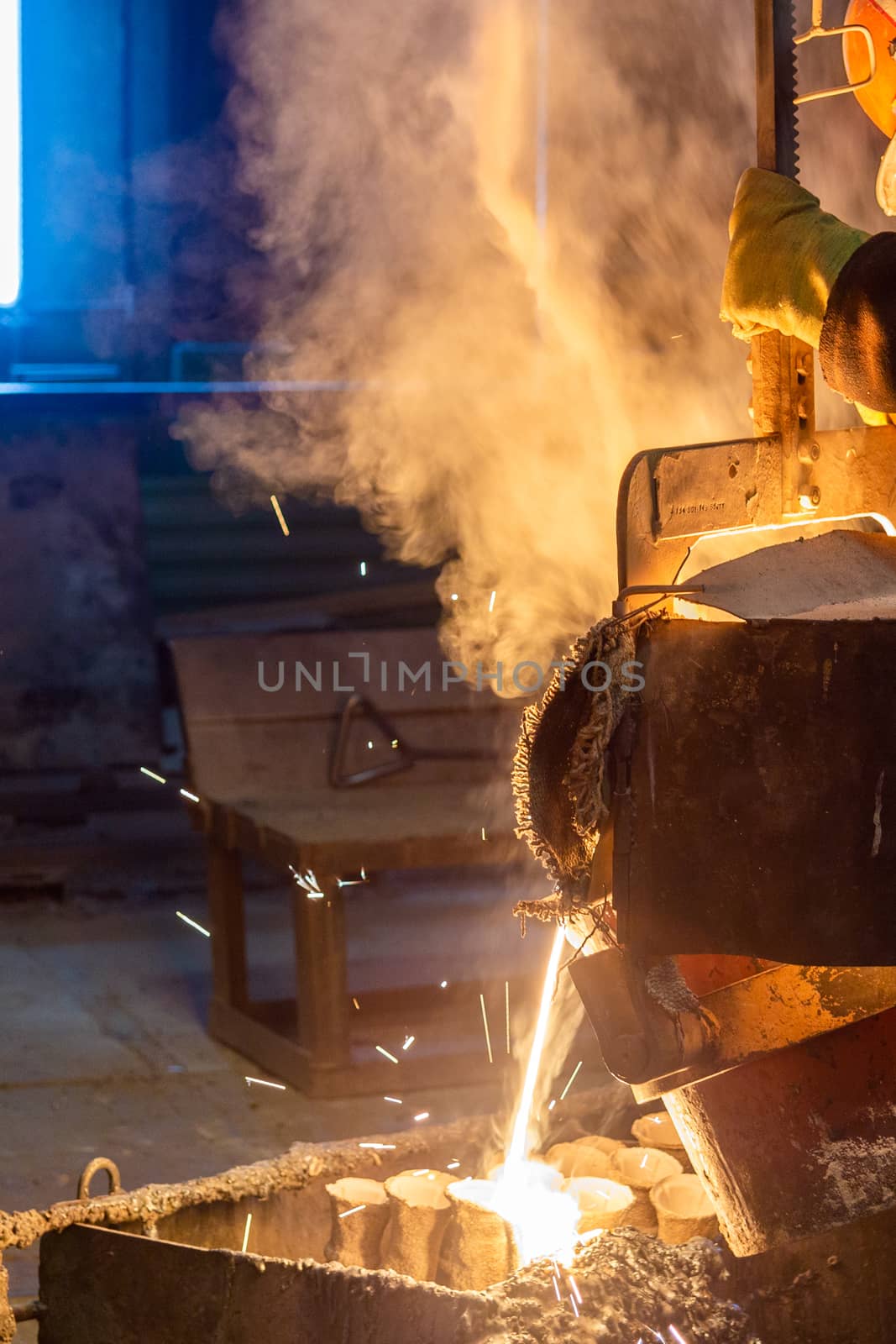 Industrial lost wax casting. The process of pouring for filling out ceramic shells with molten steel. by z1b