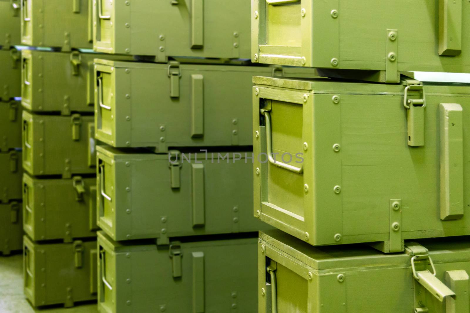 stacks of abstract green military crates without any markings - close-up with selective focus and background blur by z1b