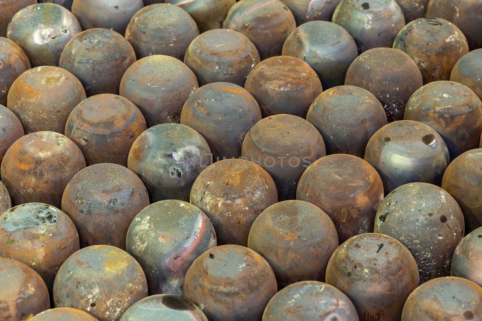 abstract full frame industrial background of rusted steel dome round workpieces after thick sheet steel draw process