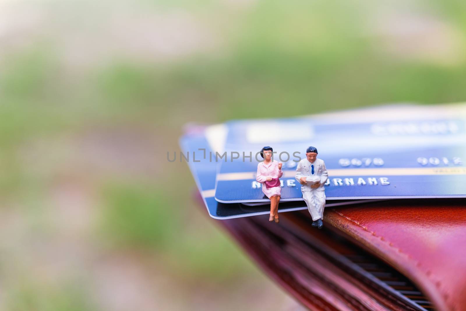 Miniature people : business people sitting on Credit card , Business and Finance concepts