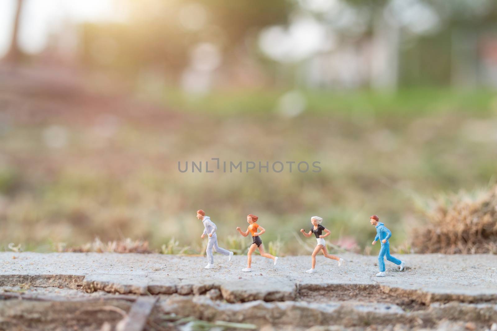 Miniature people : Running on the road with nature background , Health And lifestyle concepts