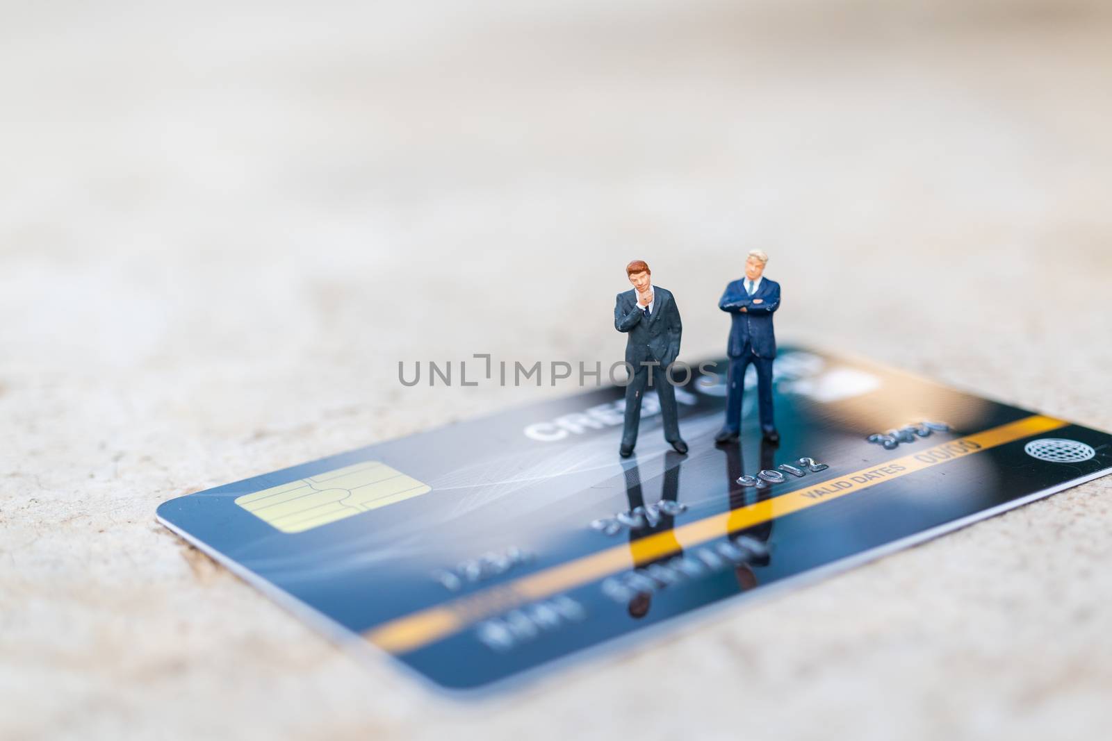 Miniature people : business people sianding on Credit card  by sirichaiyaymicro