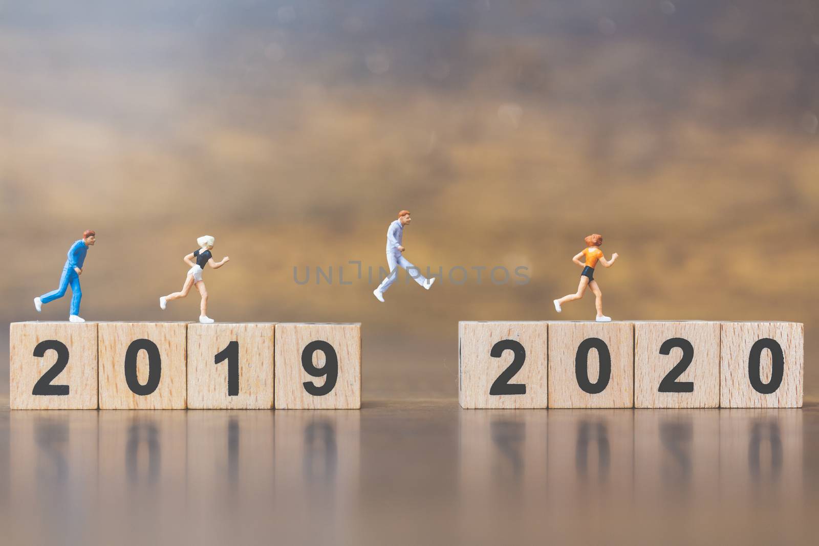 Miniature people Jump from number 2019 to number 2020 , Happy new year concepts.