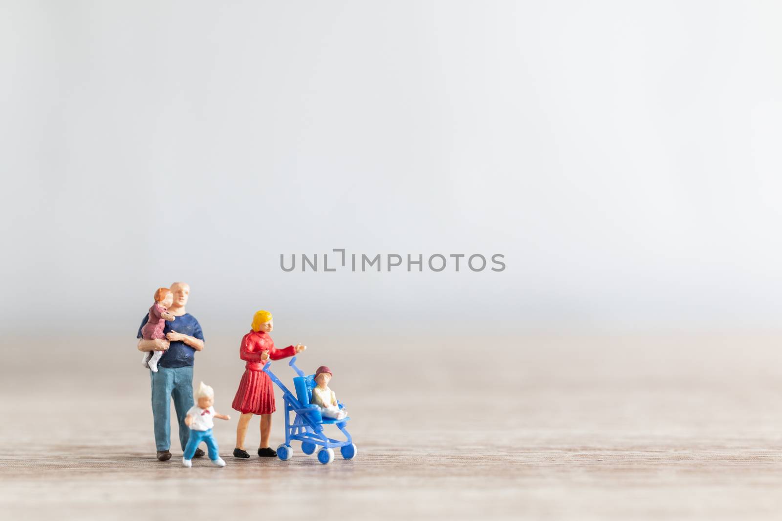 Miniature people : Parents with children walking outdoor , Happy family concept