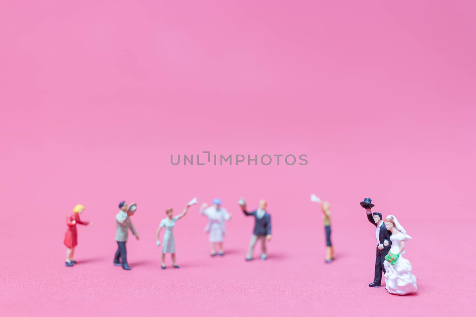 Miniature people wedding , Bride and groom on pink background , Valentine's day concept