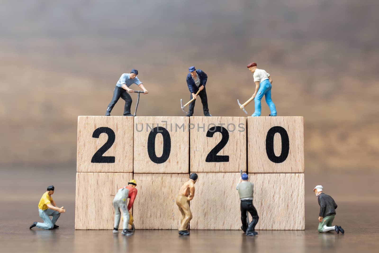 Miniature people : Worker team create wooden block number 2020  , Happy new year concept