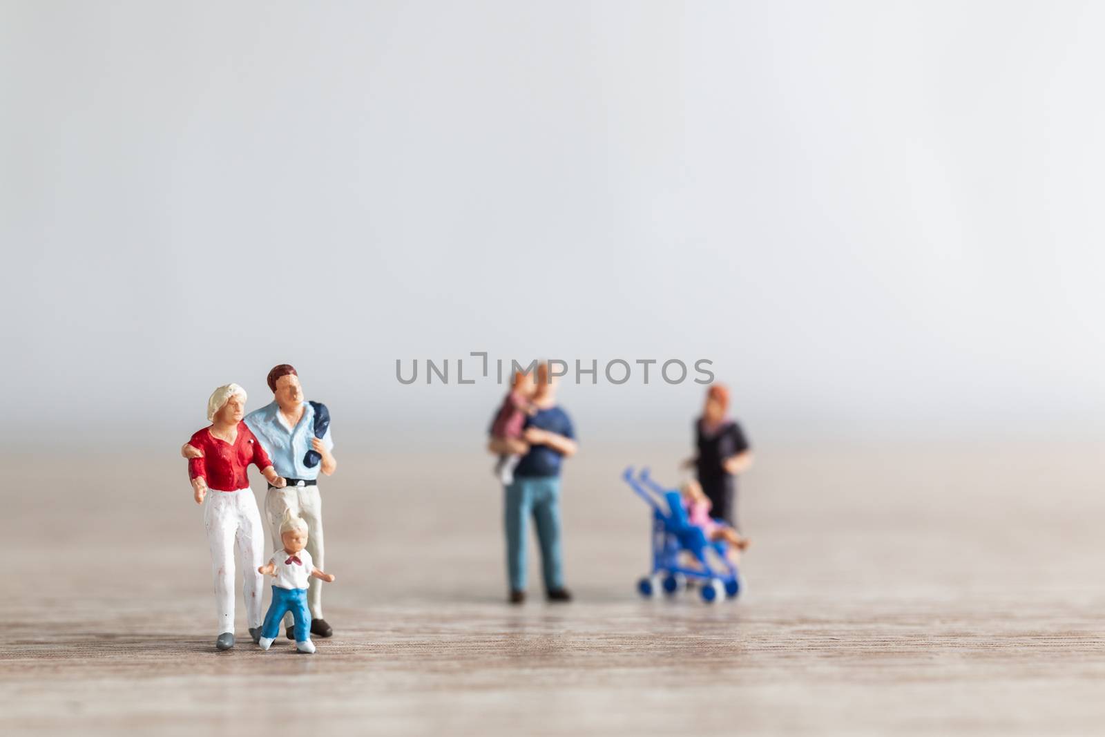 Miniature people : Parents with children walking outdoor , Happy family concept