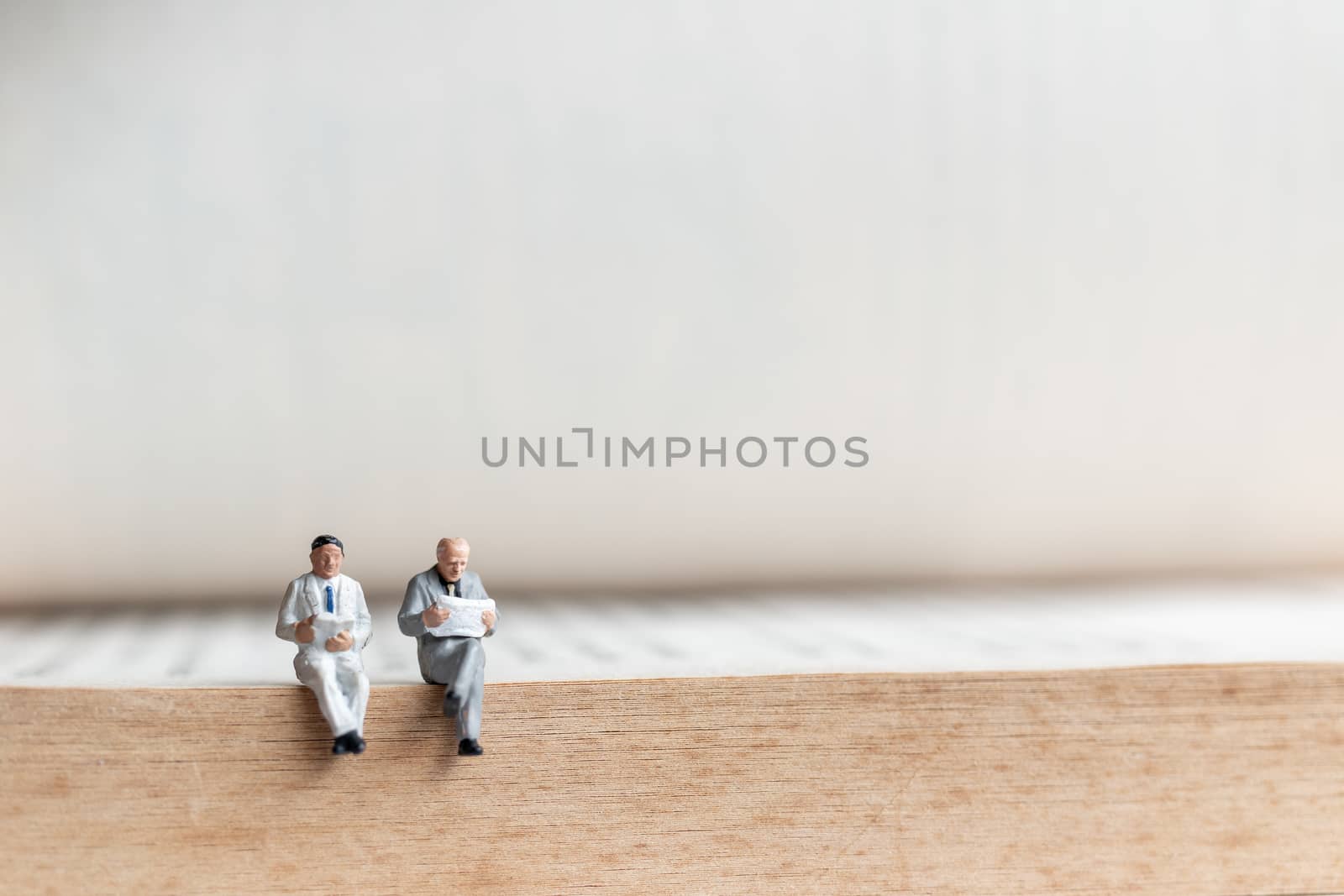 Miniature people: Businessman reading book on  old book  , Education or business concept.