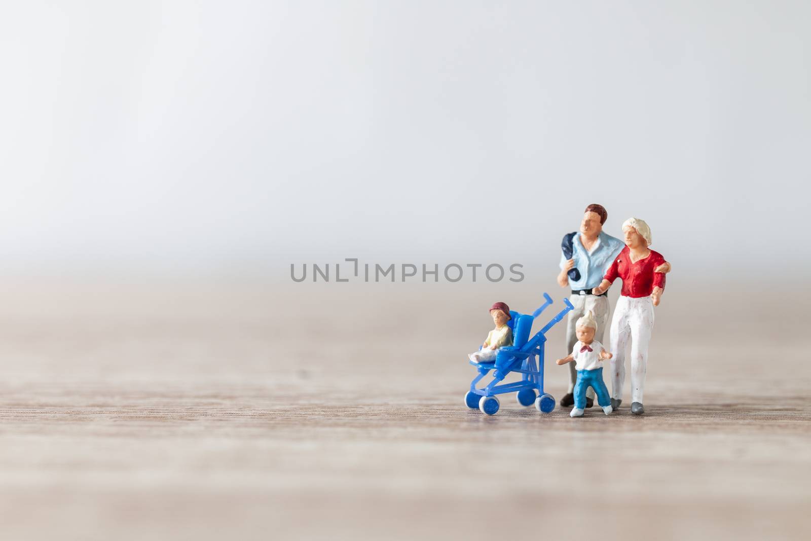 Miniature people : Parents with children walking outdoor , Happy family concept