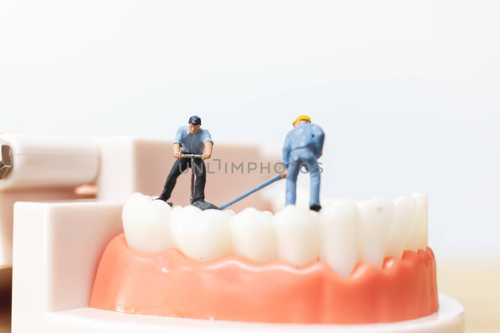 Miniature people : Worker team repairing a tooth ,Healthcare and medical concept
