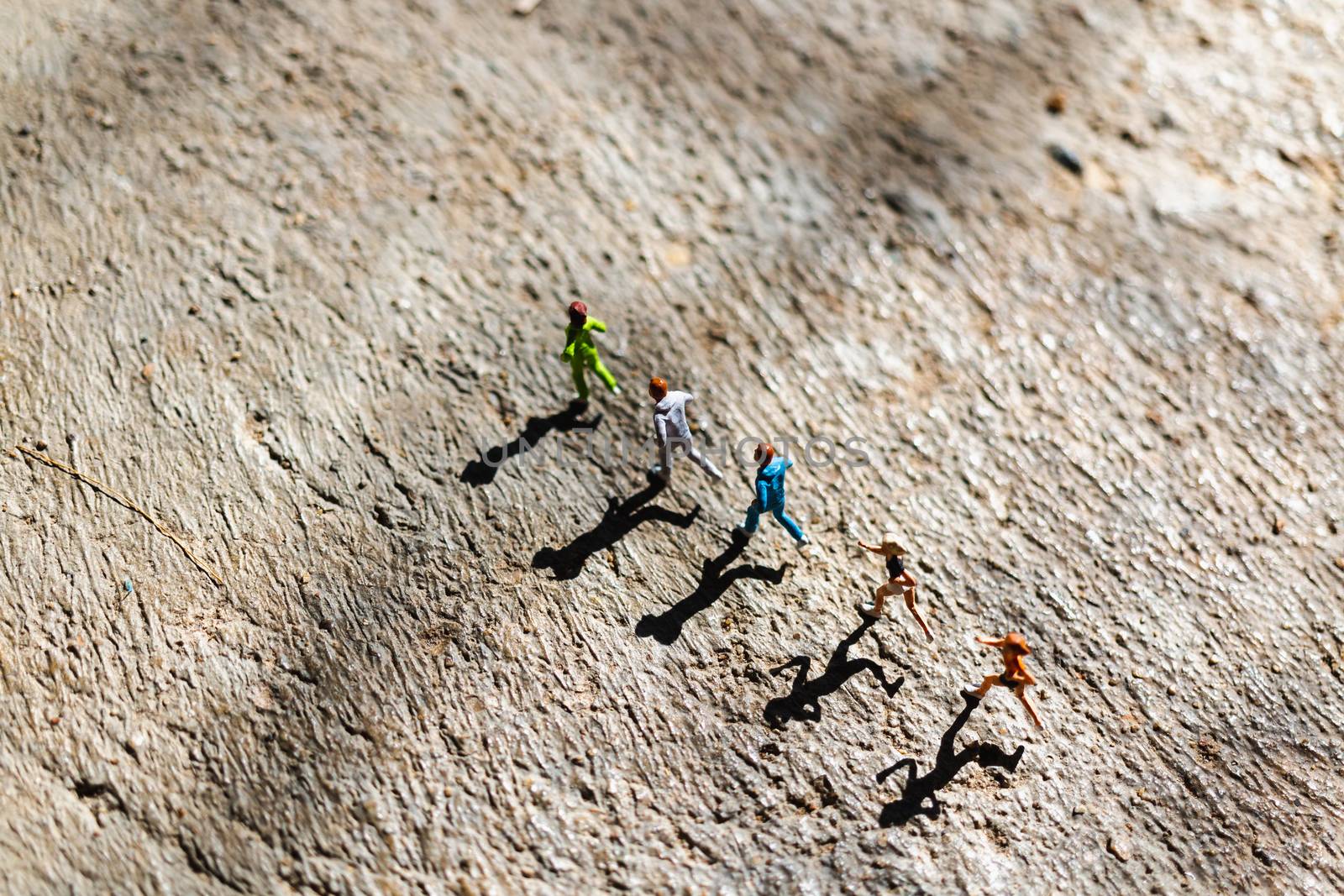 Miniature people : Group of people are running  on concrete floo by sirichaiyaymicro