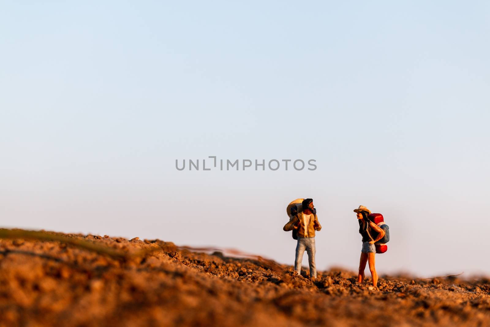 Miniature people : Traveler with backpack mountaineering. Hiking man with backpack walking outdoor