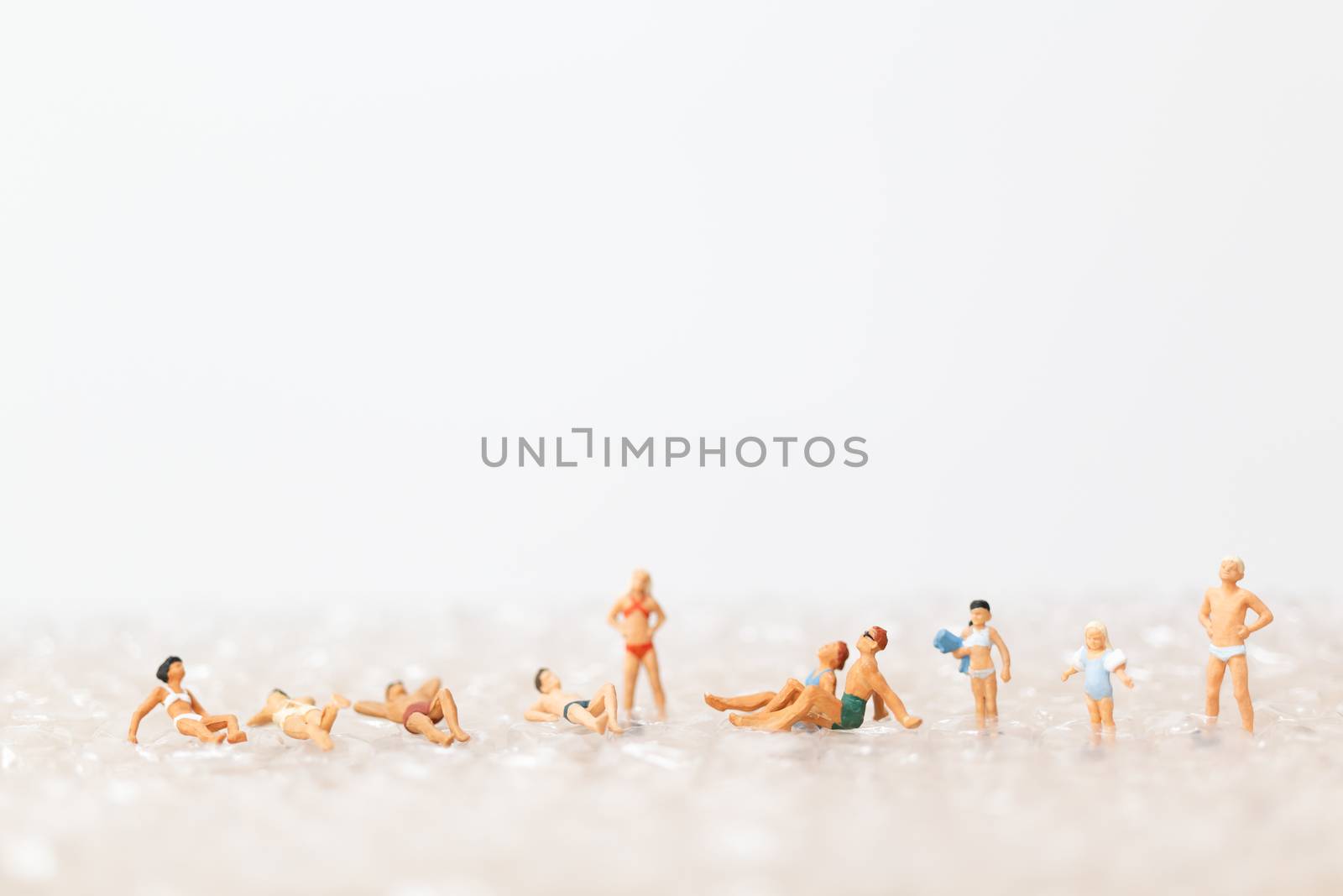 Miniature people wearing swimsuit relaxing on bubble  , vacation concept