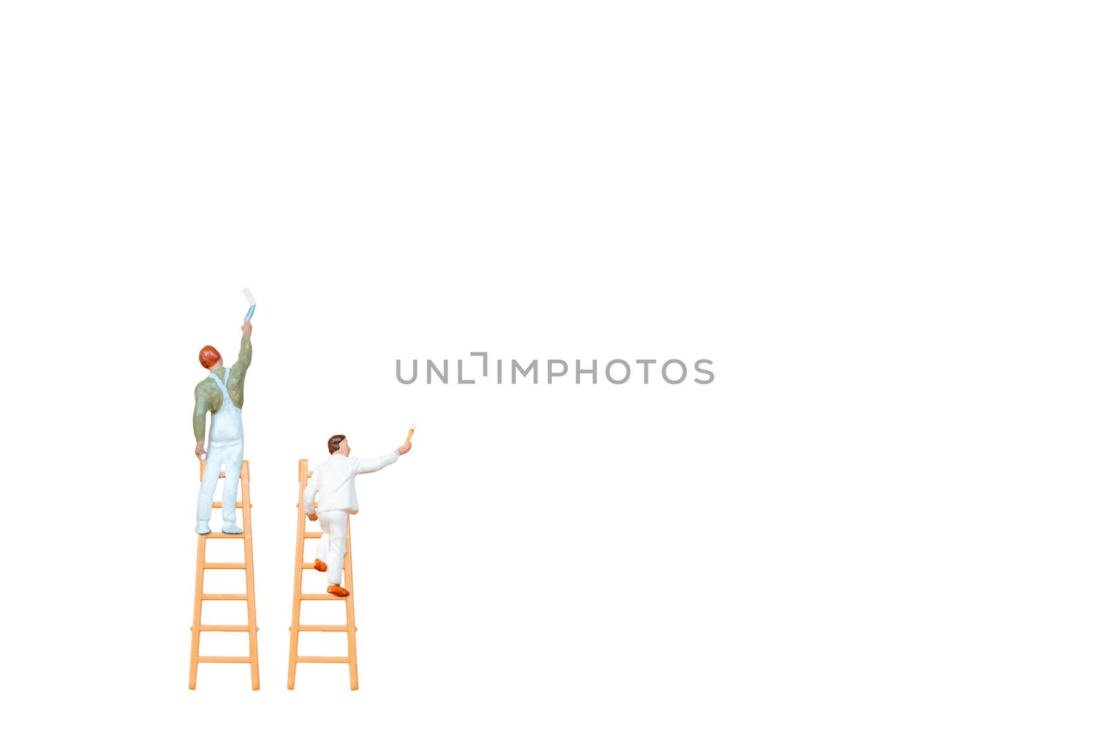 Miniature people with ladder holding brush in front of a white wall background