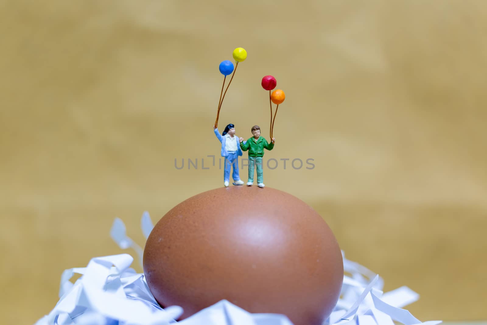 Miniature people : Happy family holding balloon celebrating Easter eggs