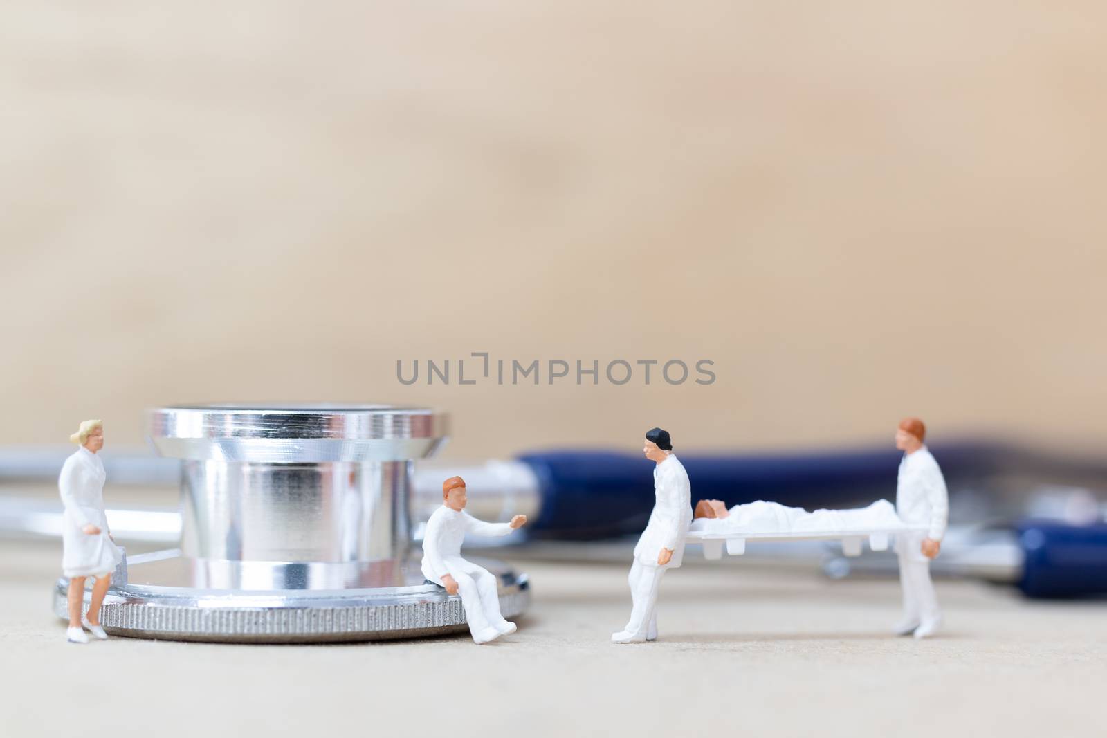 Miniature people : Doctor with nurse carry the patient on a stretcher. Healthcare  concept.