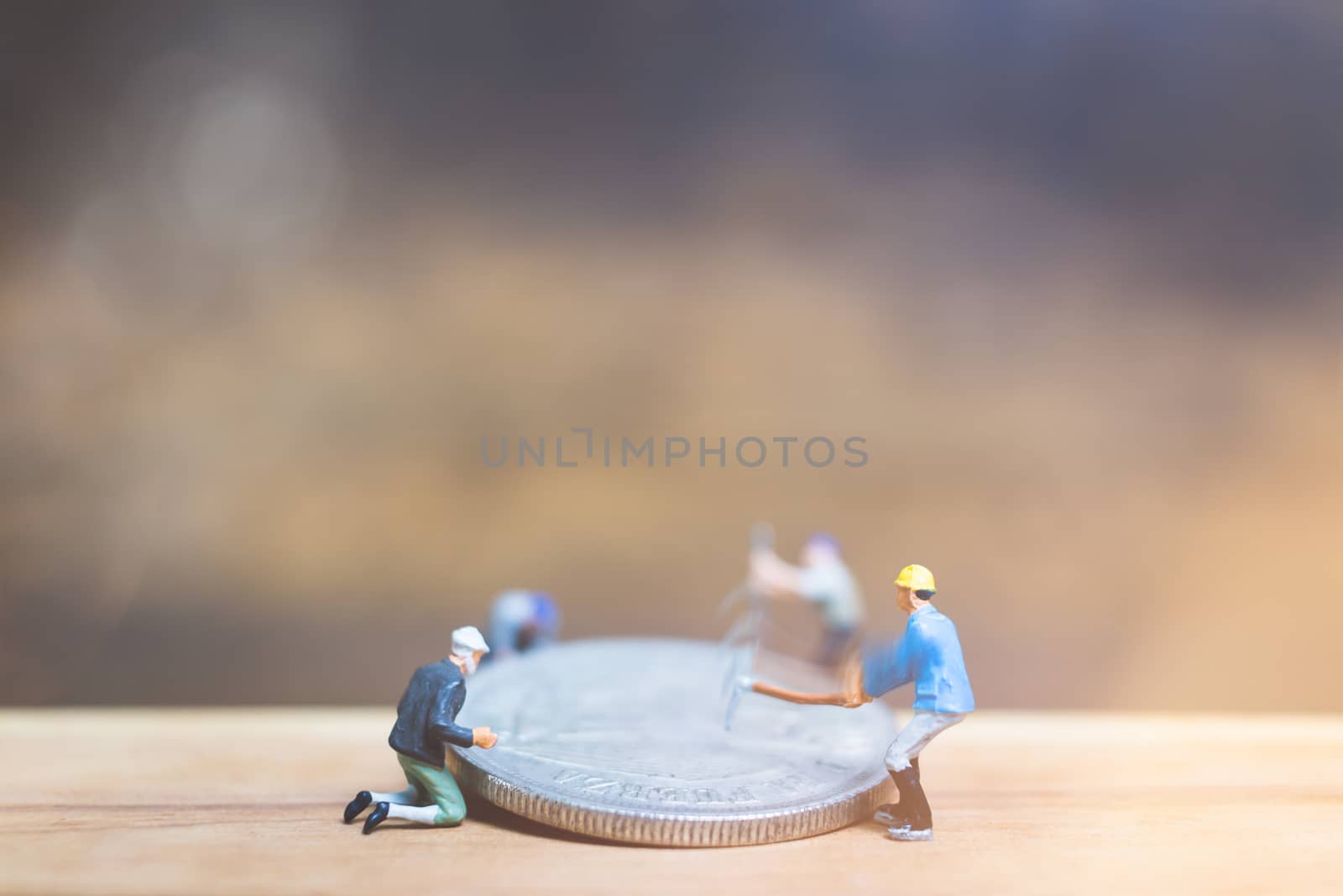 Miniature people : Worker team making money on wooden background