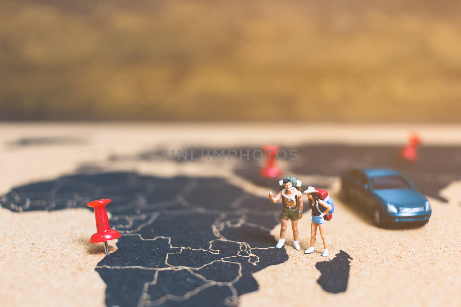 Miniature people travelers walking on world map , Traveling and exploring the world Concept