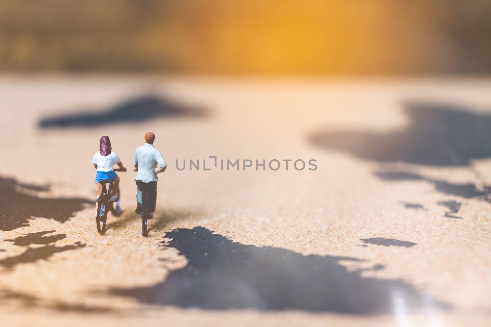 Miniature people travelers riding bicycle on world map , Traveling and exploring the world Concept