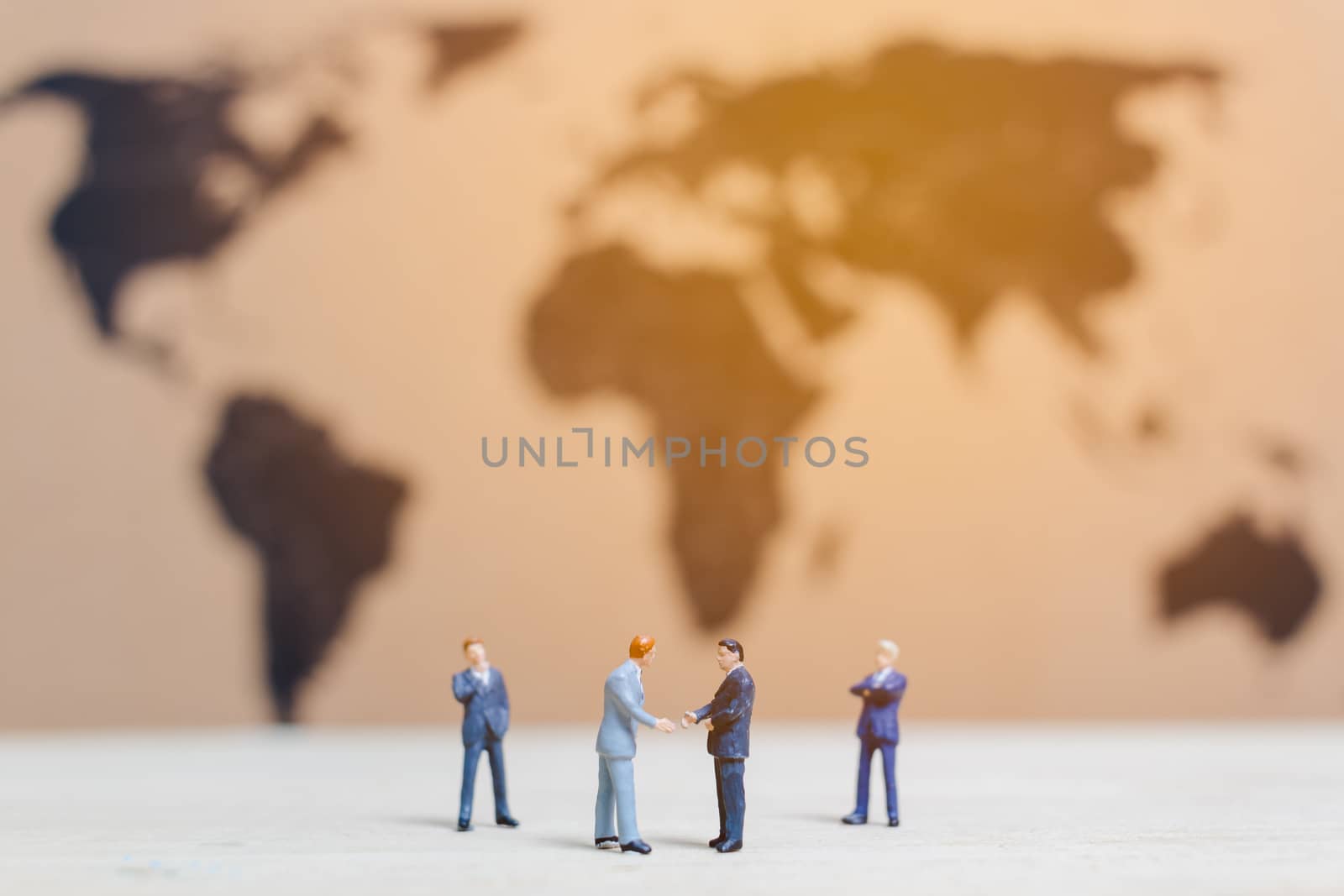 Miniature people :Businessman standing on world map Background , Growing business concept