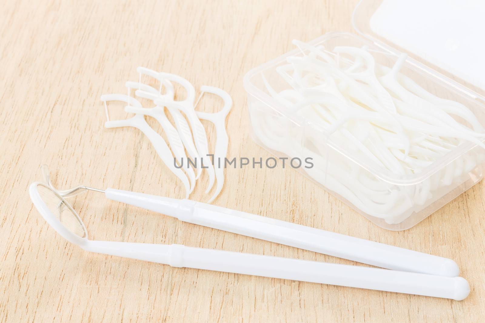 Oral Device : A box of white dental floss on wooden background