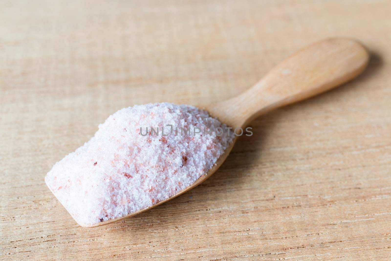 Pink salt , Himalayan salt on wooden background