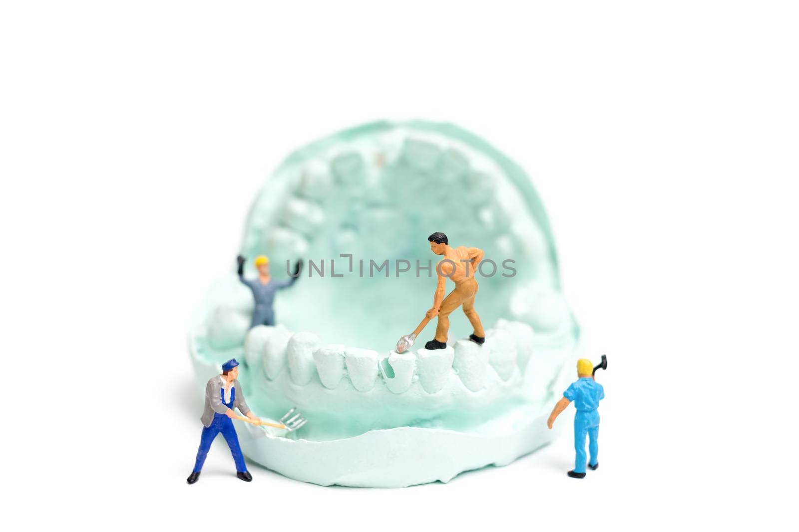 Miniature Worker team is filing fake teeth by sirichaiyaymicro