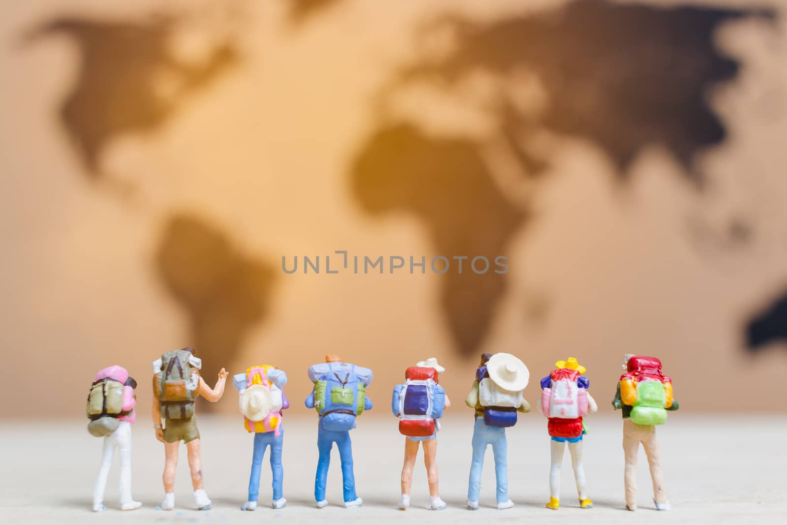 Miniature people travelers walking on world map , Traveling and exploring the world Concept