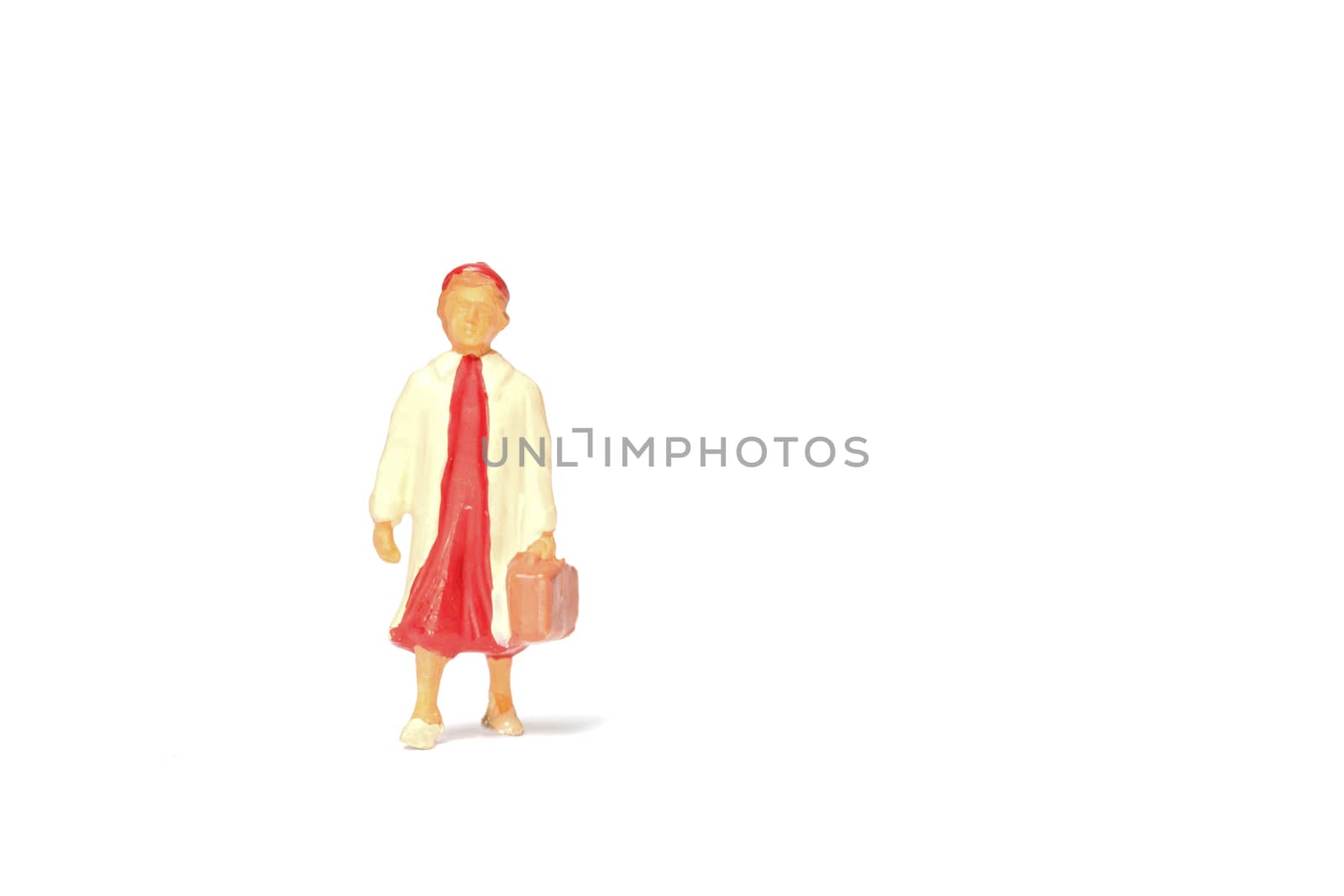 Miniature people ; Traveler holding a handbag standing on white background , Travel concept